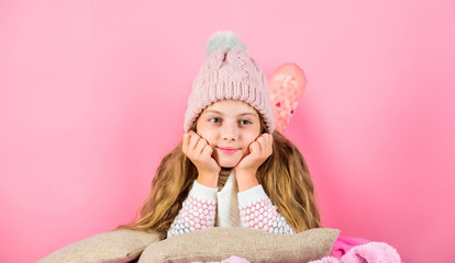 Winter fashion accessory. Kid girl knitted hat and scarf. Winter accessory concept. Girl long hair dream pink background. Winter season concept. Kid dreamy wear knitted hat. Winter rest and relax