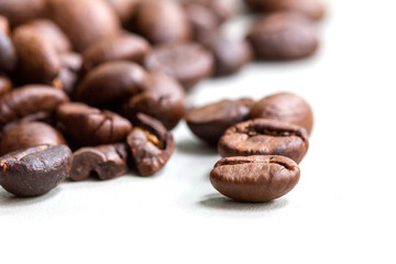 Roasted coffee beans isolated on a white background.