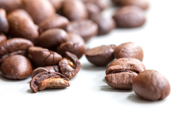 Roasted coffee beans isolated on a white background.