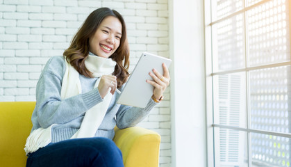 close up on asian woman using tablet portable at home , lifestyle people concept	
