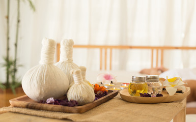 Selective focus Herbal compress balls with oil, on the wooden table in spa salon.  alternative medicine and relaxation Concept.