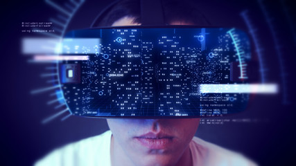 Young man wearing VR headset and watching business and economy related graphics.