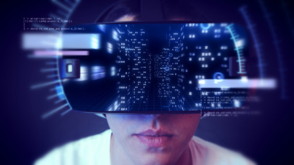 Young man wearing VR headset and watching business and economy related graphics.
