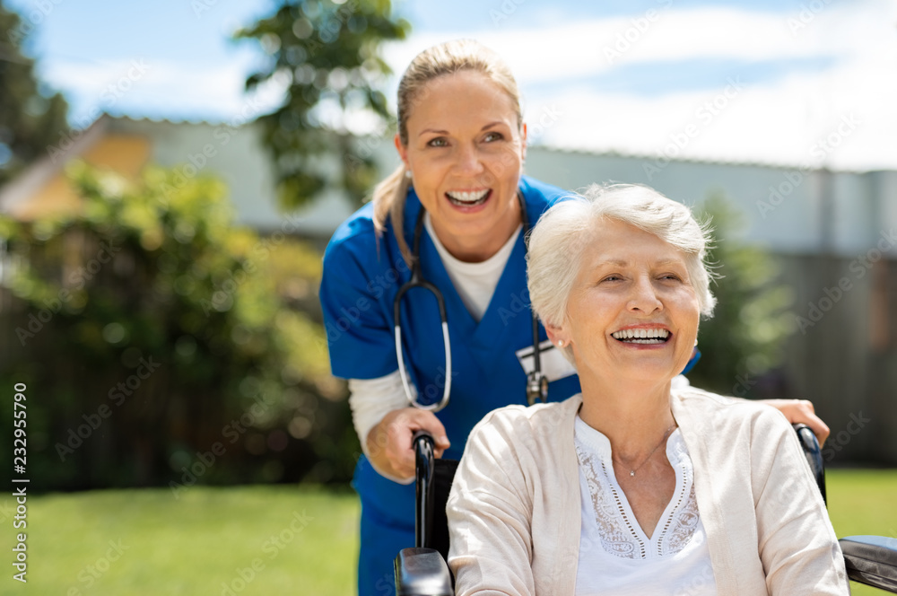 Canvas Prints Woman on wheelchair having fun with nurse