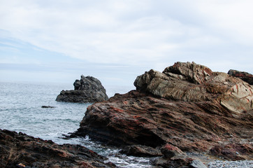 Fototapeta na wymiar Photograph of a beautiful landscape of a beach of rocks and stones in Menorca.