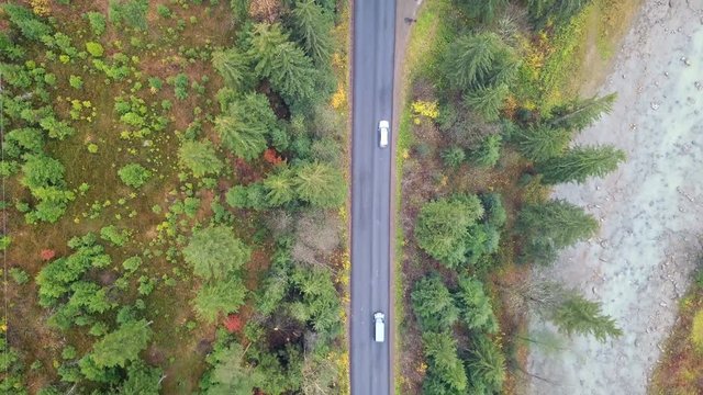 Aerial view of the movement of vehicles on a mountain road. Carpathians. Ukraine. Top view