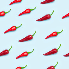 Pattern Red bitter chili pepper on blue background Flat lay top view. Creative Food concept.
