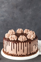 Chocolate cake with coffee cheese cream on a white plate
