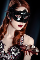 Beautiful women in carnival mask. Photo in vintage style.