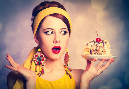 Style redhead girl in yellow clothes with cake. Photo with bokeh at background.