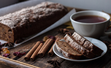 Homemade banana bread with anis star and cinnamon on a dark wooden background