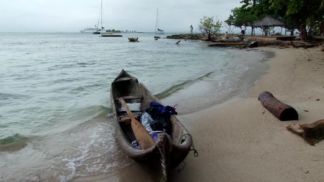 Indigenous Guna canoe on beach  in the San Blas Islands during stormy day