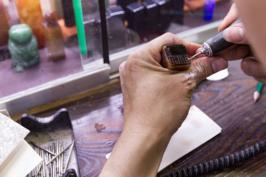 Hombre haciendo tamp&oacute;n de tinta con nombre de mujer.