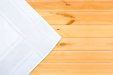 White table cloth on wooden table. Top view mockup.