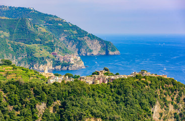 Fototapeta na wymiar Corniglia - Village of Cinque Terre National Park at Coast of Italy. In the background you can see Manarola. Province of La Spezia, Liguria, in the north of Italy - Travel destination in Europe.