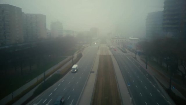 Flight over blurred city street in fog