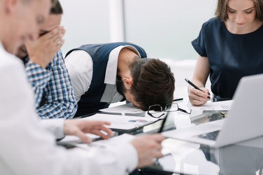 tired employee at a business meeting in the office