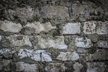 the texture of an old white brick masonry with remnants of plaster
