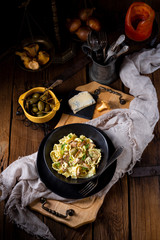 Reginette noodles in cream sauce with fresh chanterelles and capers