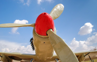 Propeller of vintage airplane on blue sky background