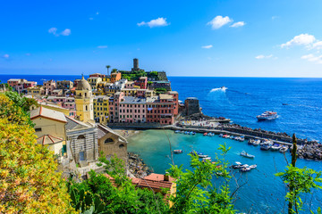 Fototapeta na wymiar Vernazza - Village of Cinque Terre National Park at Coast of Italy. Beautiful colors at sunset. Province of La Spezia, Liguria, in the north of Italy - Travel destination and attractions in Europe.