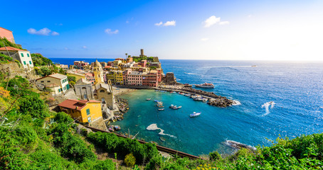 Naklejka na ściany i meble Vernazza - Village of Cinque Terre National Park at Coast of Italy. Beautiful colors at sunset. Province of La Spezia, Liguria, in the north of Italy - Travel destination and attractions in Europe.
