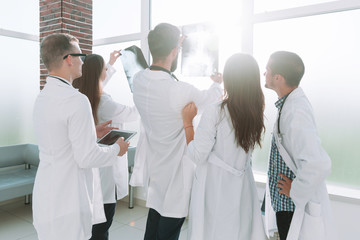 group of doctors looking at a patient's x-ray.