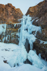 Fototapeta na wymiar Frozen Waterfall near Jebel Toubkal peak, Atlas mountains, Morocco