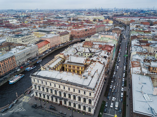 Autumn cloudy day with view of rooftops; different architecture style houses, mansions with cultural history; popular touristic water rout in Saint Petersburg with usual foggy cityscape and channels