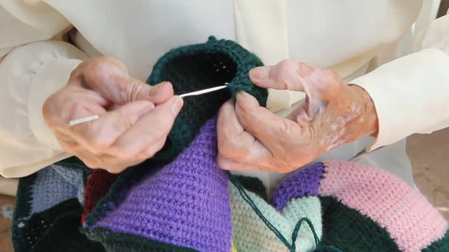 Old woman crocheting.