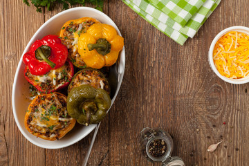 Colorful baked with cheese, stuffed peppers with rice and minced meat.