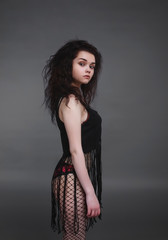 Fototapeta premium Portrait of a girl on a dark background in the studio