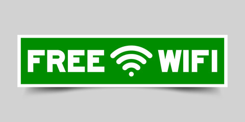 Green and white color free wifi with signal icon sticker on gray background