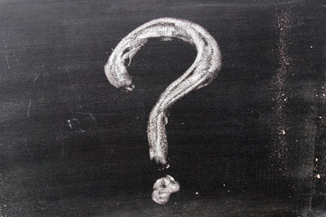 White color chak hand drawing in question mark shape on blackboard background