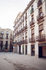 Fototapeta na wymiar Old Buildings on Cucurulla Street in Barcelona, Spain. Empty Barcelona Street.