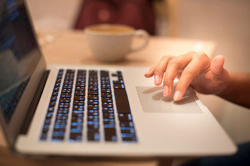 Close up hands of Asian young woman using her laptop..