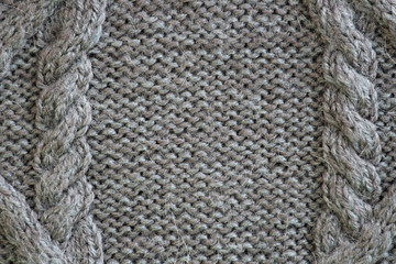 Close up texture of cable knit yarn. gray wool with a aran