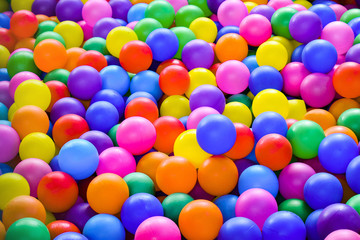 Fototapeta na wymiar Multi-colored plastic balls for dry pool close-up