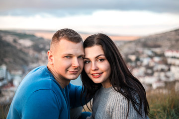 Happy couple seating outdoor near Black sea.