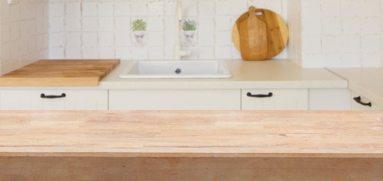 Empty white kitchen table top with white modern kitchen in background banner