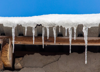 Icicles hang from the roof in winter