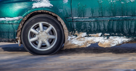 Car wheel in the snow in winter