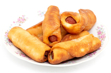 Sausage dough in a plate on a white background