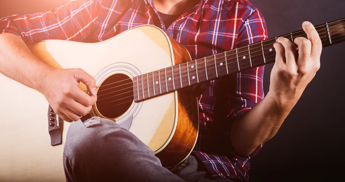 GUITARIST PLAYS ON THE ACOUSTIC GUITAR ON THE STAGE