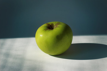 Apple on white table