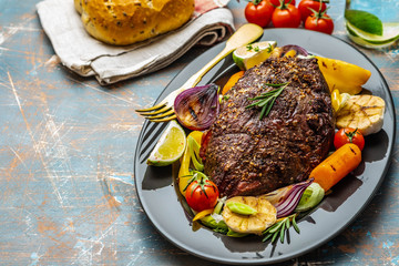 Club Beef steak with pepper sauce and Grilled vegetables on dark wooden background. Roas beef. Copy space.