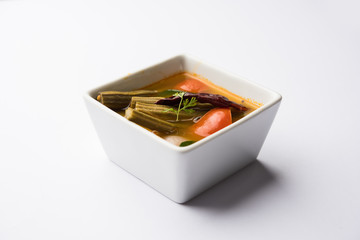 Drumstick Curry or Shevga sheng bhaji or south indian Sambar, served in a bowl over moody background. Selective focus
