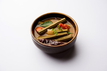 Drumstick Curry or Shevga sheng bhaji or south indian Sambar, served in a bowl over moody background. Selective focus