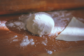 raw dough on wooden background. sunray.