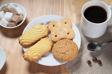 Various cookies with coffee and sugar cubes